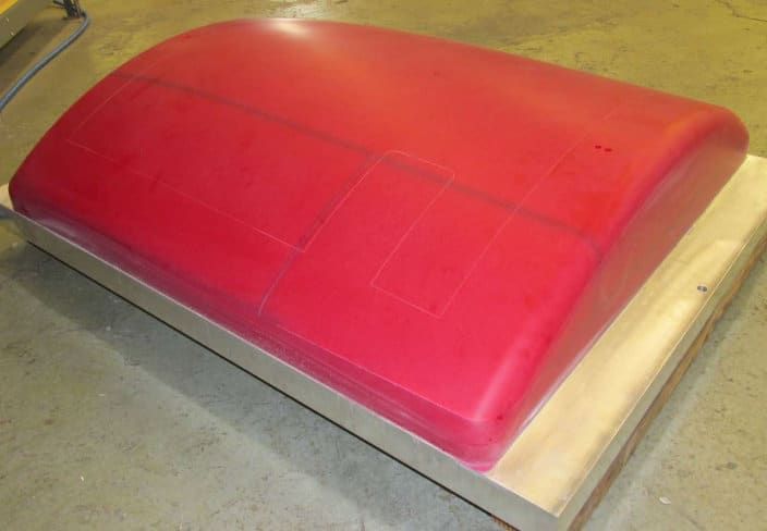 Red urethane stretch form die on a steel base